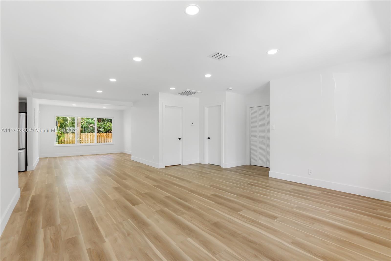 269 Northwest 12th Street Boca Raton, FL 33432 - Photo 4 of 18 a view of an empty room with wooden floor and a window