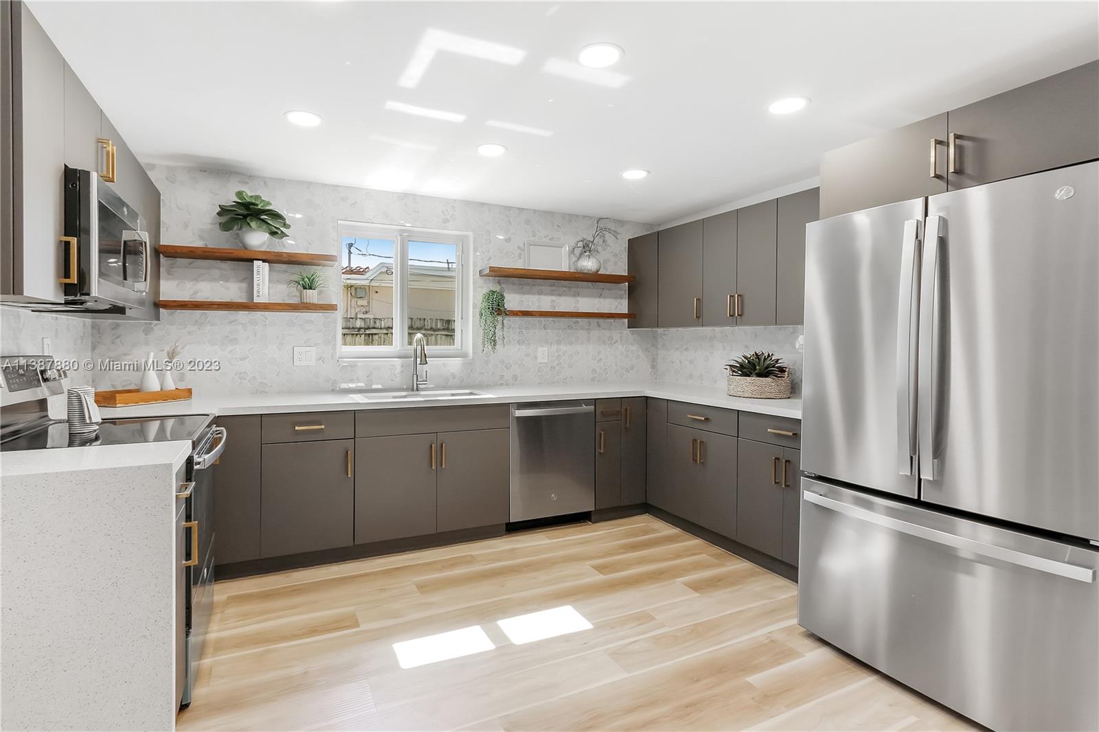 269 Northwest 12th Street Boca Raton, FL 33432 - Photo 7 of 18 a kitchen with granite countertop a refrigerator and a sink