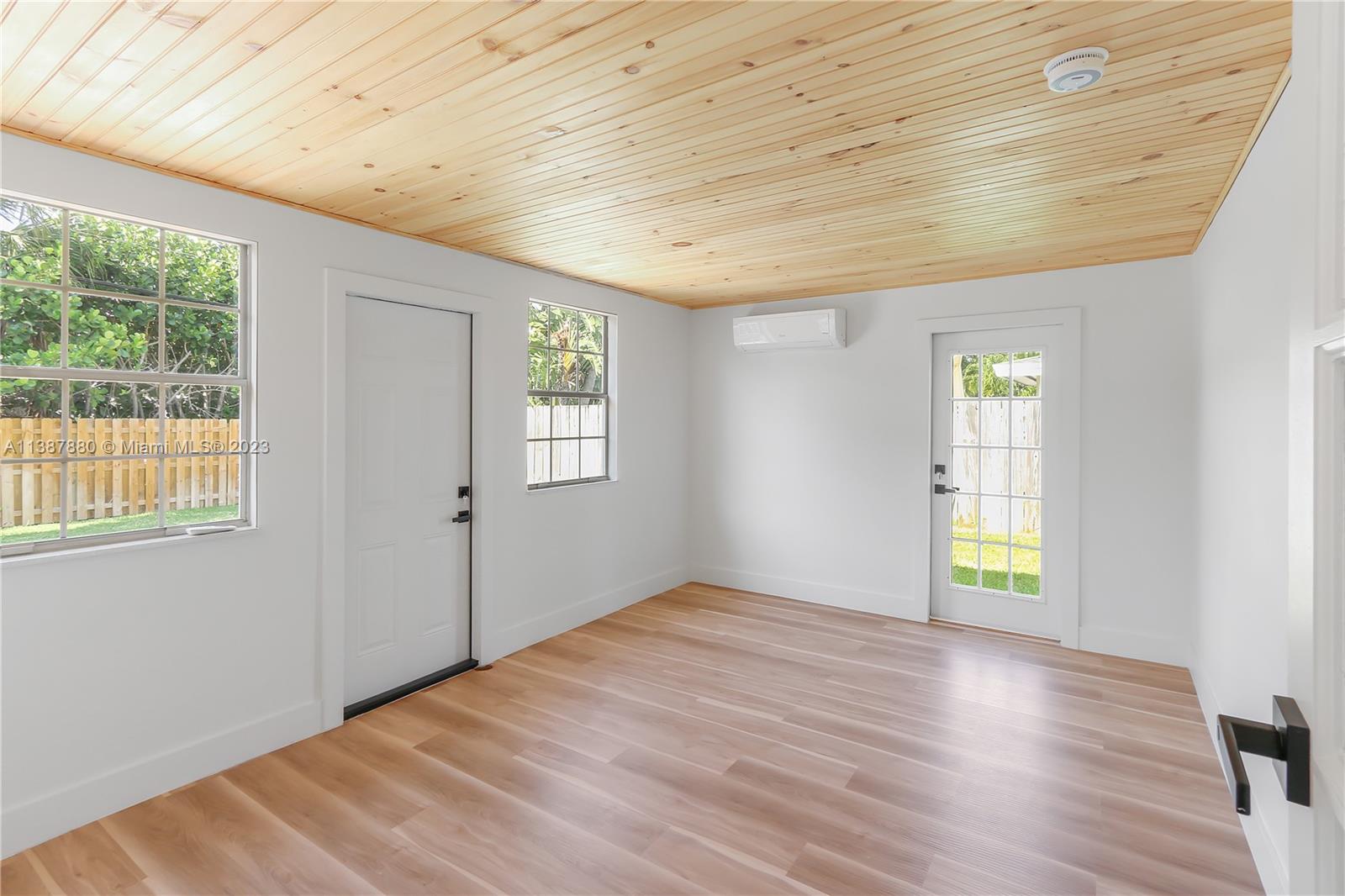 269 Northwest 12th Street Boca Raton, FL 33432 - Photo 9 of 18 a view of an empty room with wooden floor and a window