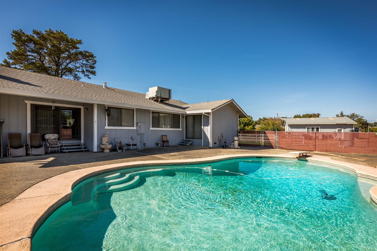 9403 Alta Mesa Road Wilton, CA 95693 - Photo 1 of 1 front view of a house with swimming pool and a yard