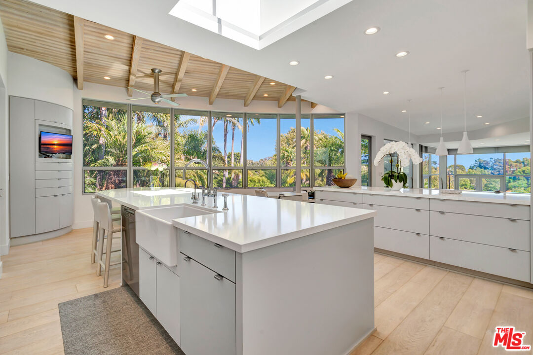 28775 Sea Ranch Way Malibu, CA 90265 - Photo 2 of 21 a kitchen with stainless steel appliances granite countertop a sink and a large window