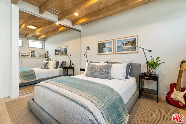 a bed room with two beds and a potted plant