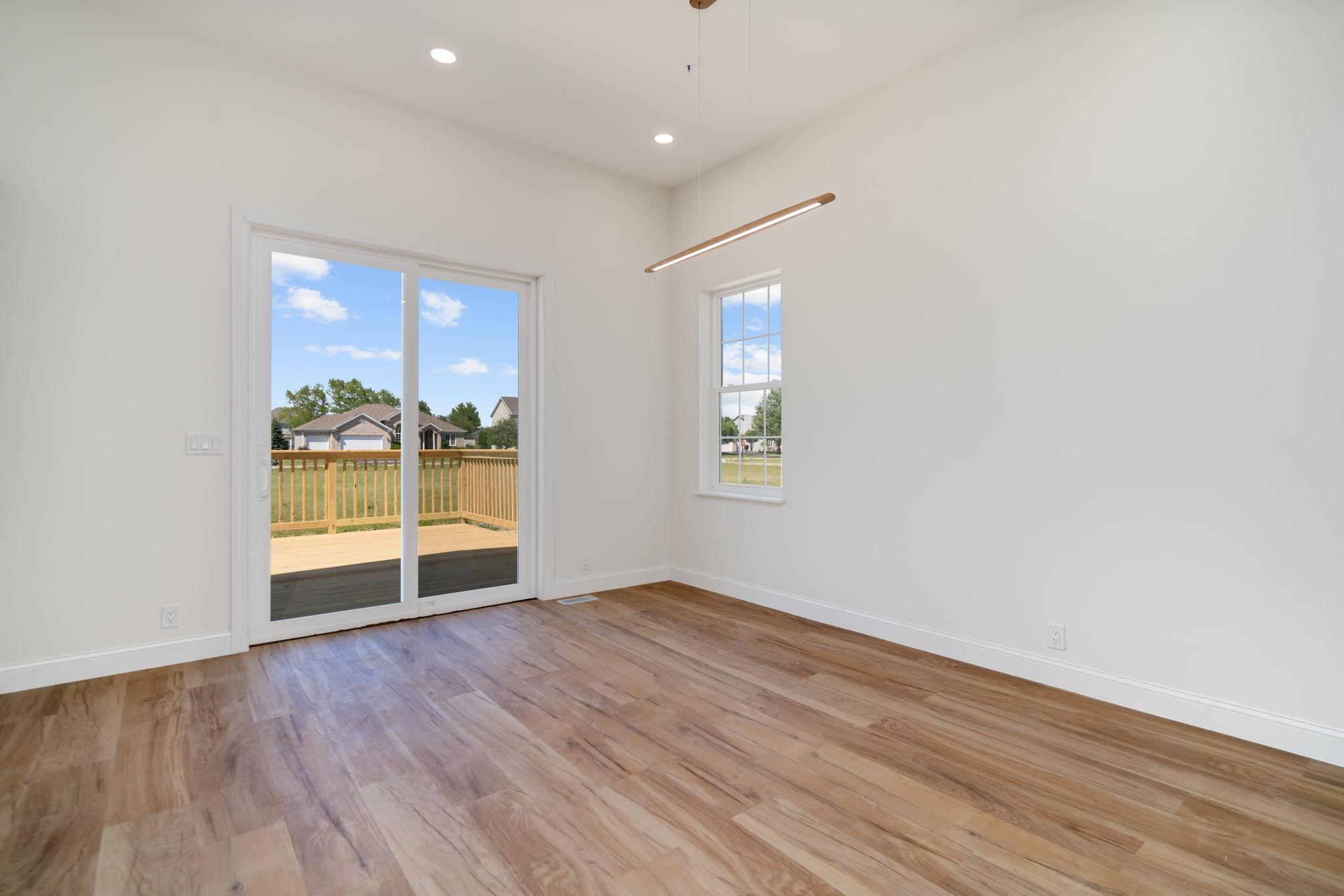 5145 Sycamore Ridge Road Belvidere, IL 61008 - Photo 10 of 57 an empty room with wooden floor and windows