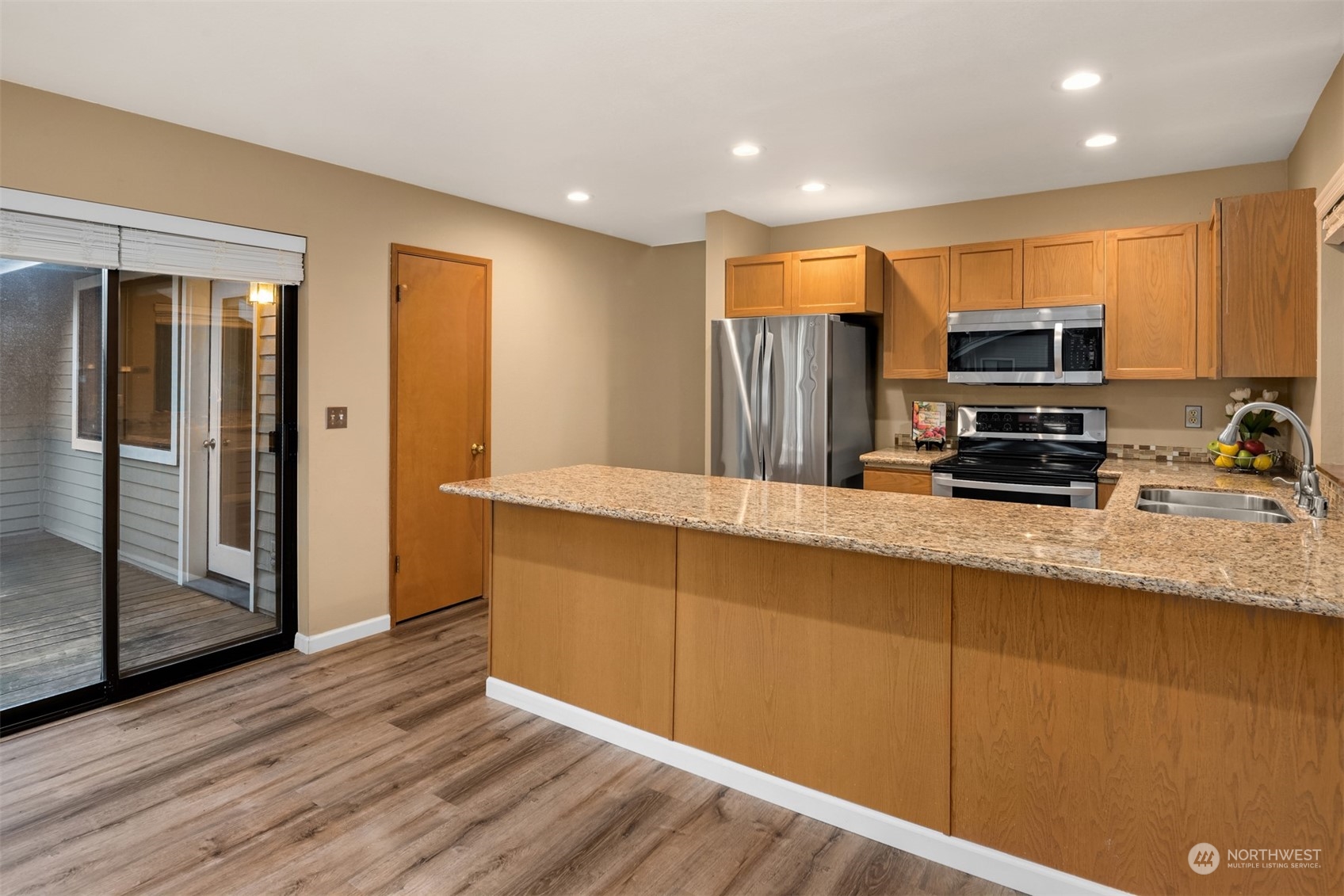 9009 Avondale Road Northeast, Unit R 235 Redmond, WA 98052 - Photo 12 of 24 a kitchen with stainless steel appliances granite countertop a stove a sink and a refrigerator