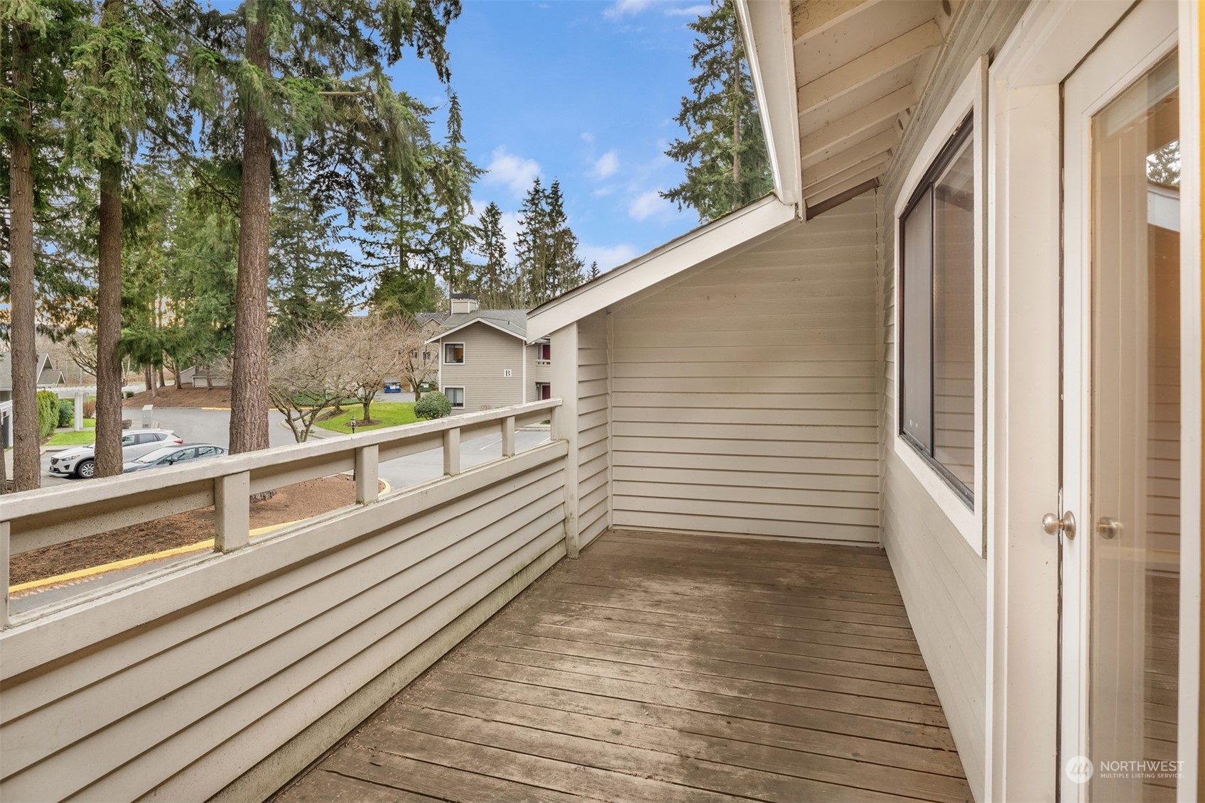 9009 Avondale Road Northeast, Unit R 235 Redmond, WA 98052 - Photo 17 of 24 a view of a balcony with wooden floor and fence