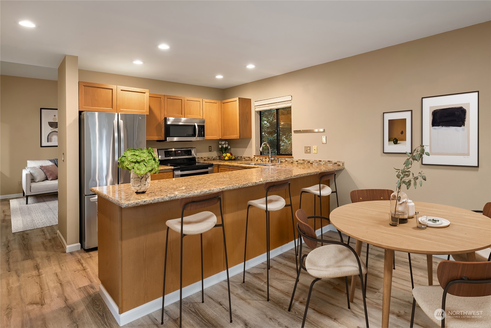 9009 Avondale Road Northeast, Unit R 235 Redmond, WA 98052 - Photo 2 of 24 a kitchen with stainless steel appliances granite countertop a table chairs and a refrigerator