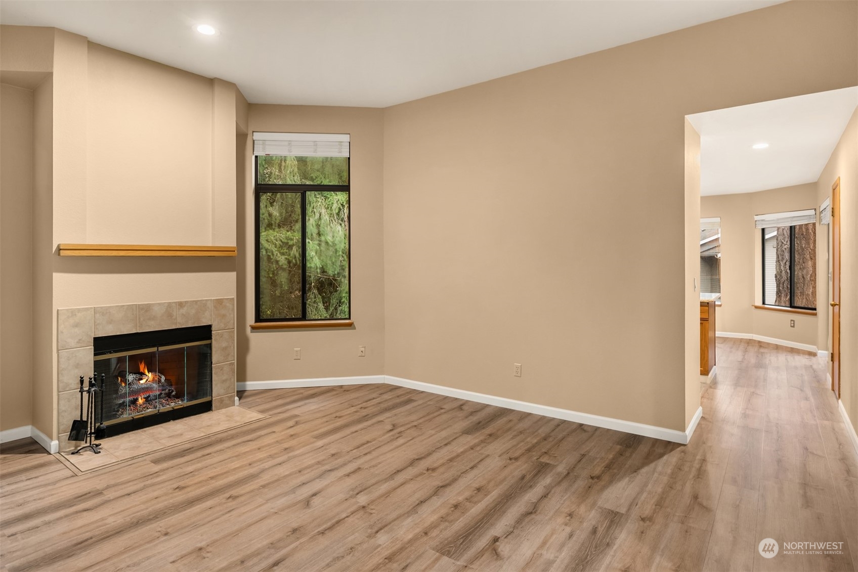 9009 Avondale Road Northeast, Unit R 235 Redmond, WA 98052 - Photo 8 of 24 a view of an empty room with wooden floor fireplace and a window