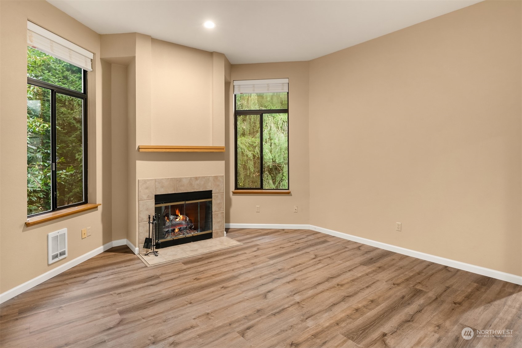 9009 Avondale Road Northeast, Unit R 235 Redmond, WA 98052 - Photo 9 of 24 an empty room with wooden floor fireplace and windows