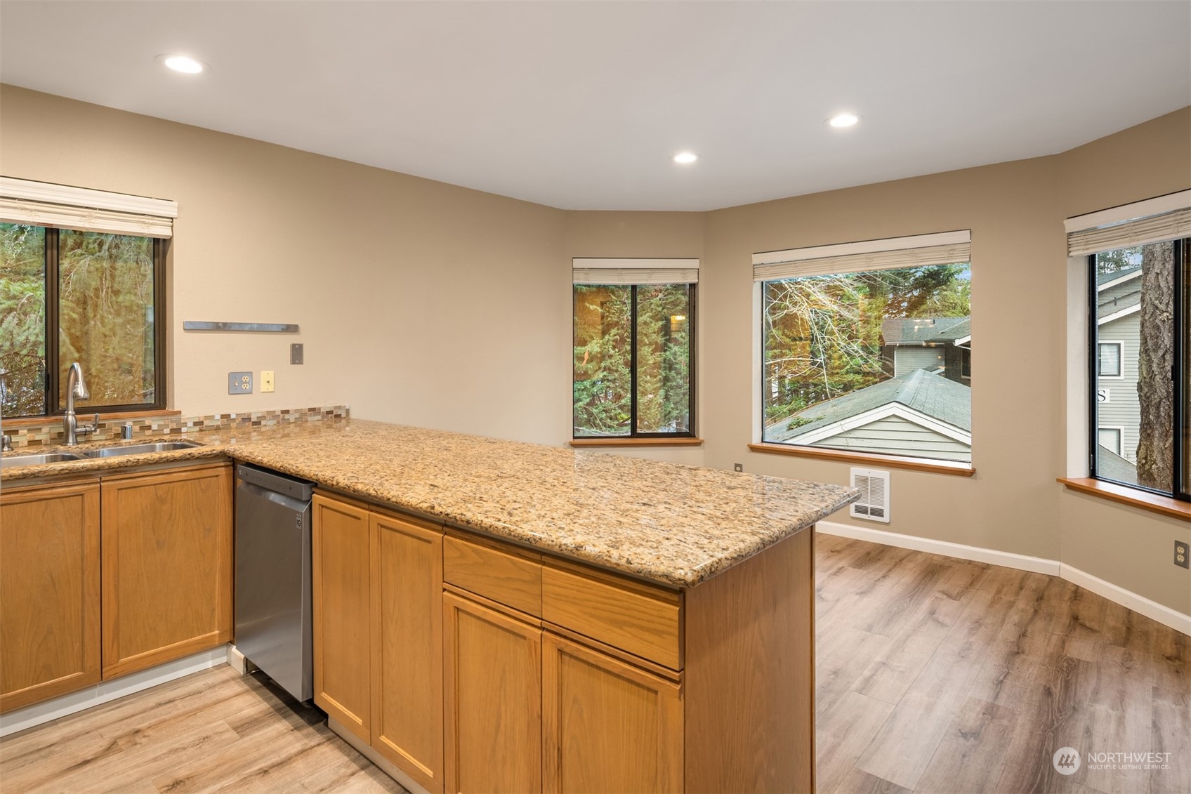 9009 Avondale Road Northeast, Unit R 235 Redmond, WA 98052 - Photo 10 of 24 a kitchen with a sink stove and cabinets