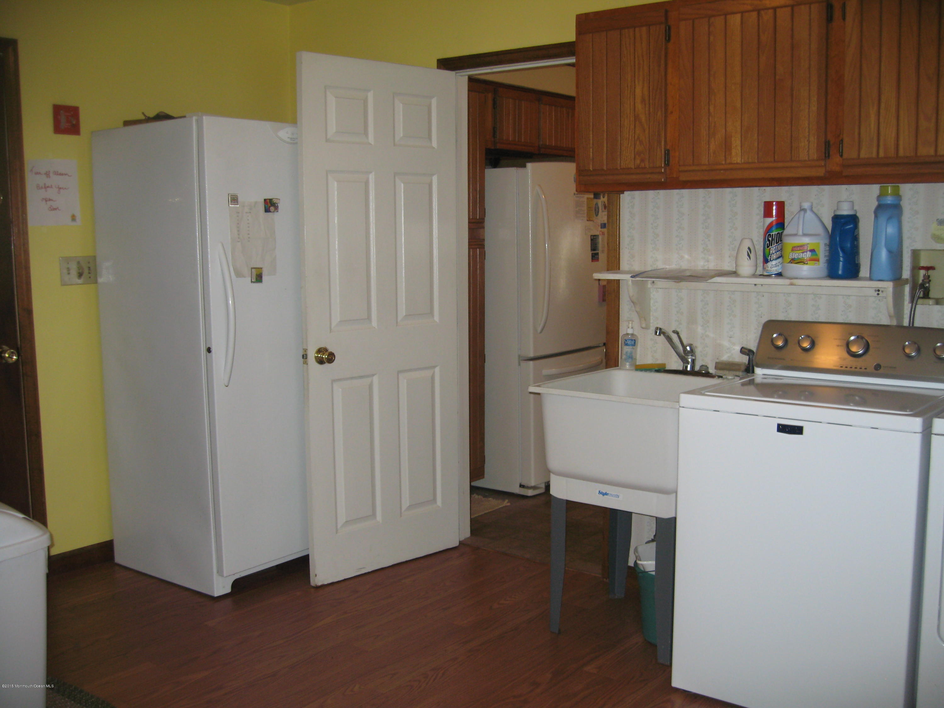 428 Oak Tree Road Freehold, NJ 07728 - Photo 13 of 18 a kitchen with refrigerator and cabinets