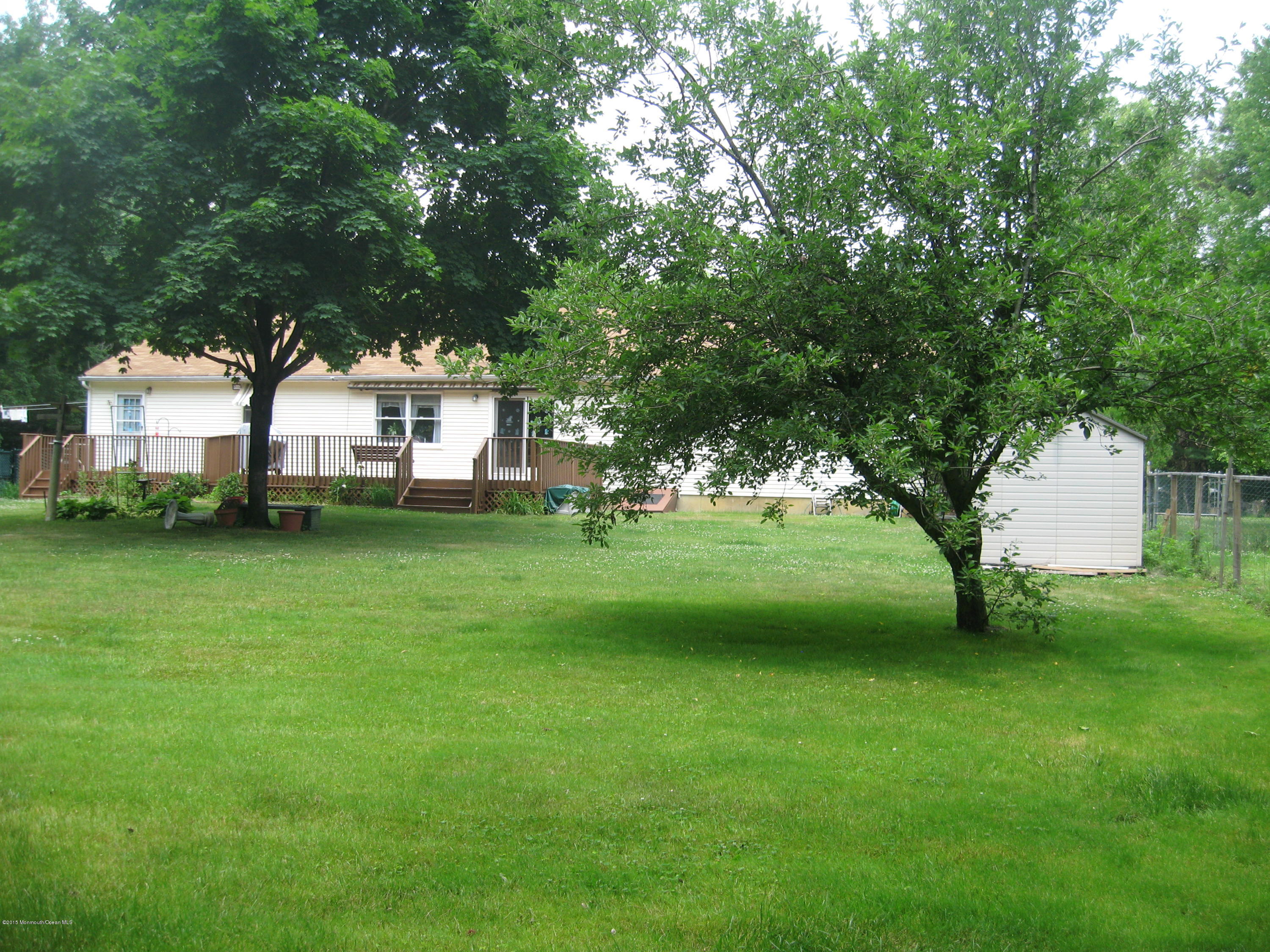 428 Oak Tree Road Freehold, NJ 07728 - Photo 15 of 18 a view of a house with a big yard and large trees