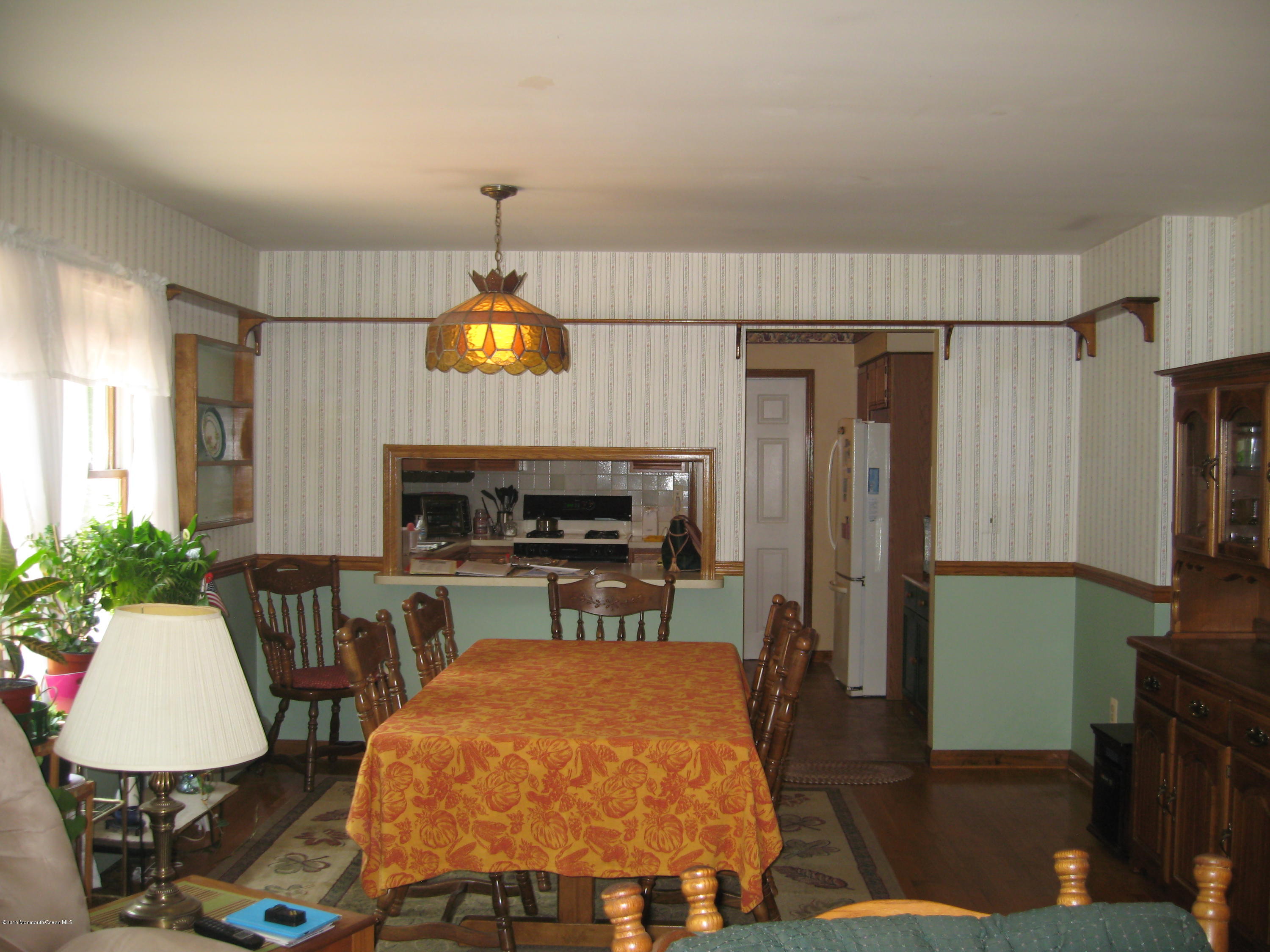 428 Oak Tree Road Freehold, NJ 07728 - Photo 7 of 18 a living room with furniture a fireplace and a flat screen tv
