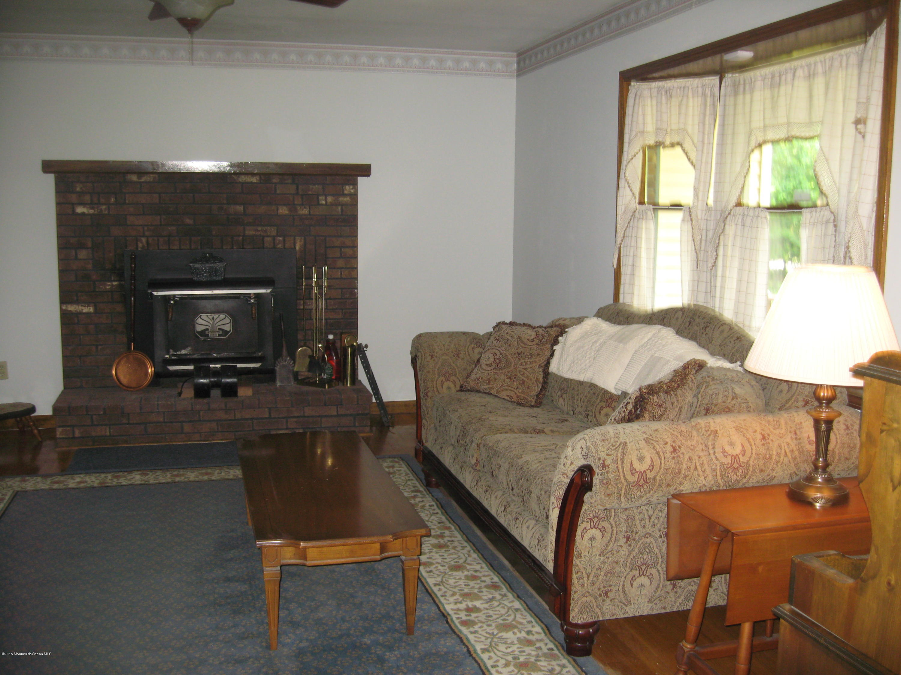 428 Oak Tree Road Freehold, NJ 07728 - Photo 9 of 18 a living room with a couch and a fireplace