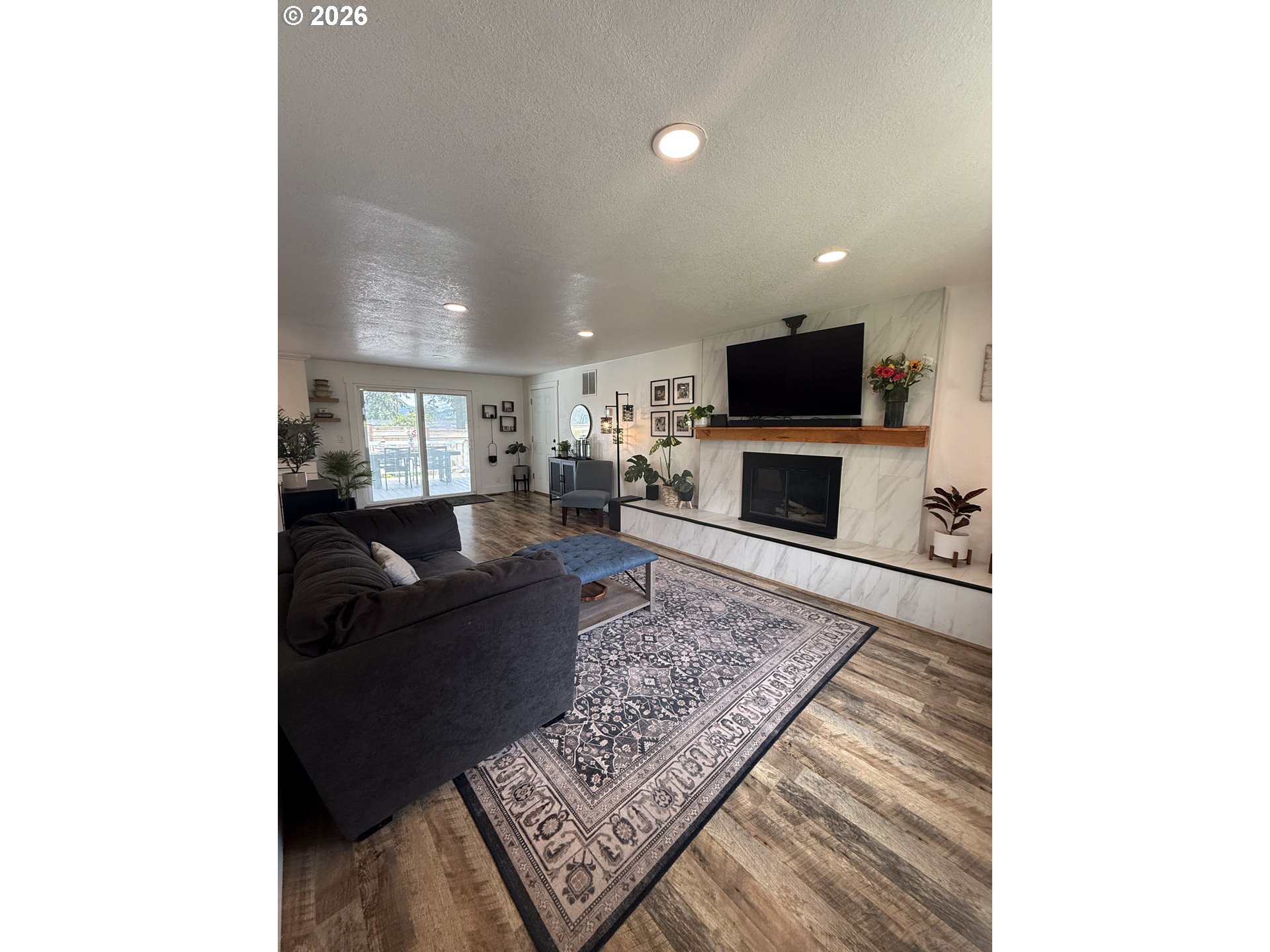 6974 Glacier Drive Springfield, OR 97478 - Photo 2 of 37 a living room with furniture and a flat screen tv