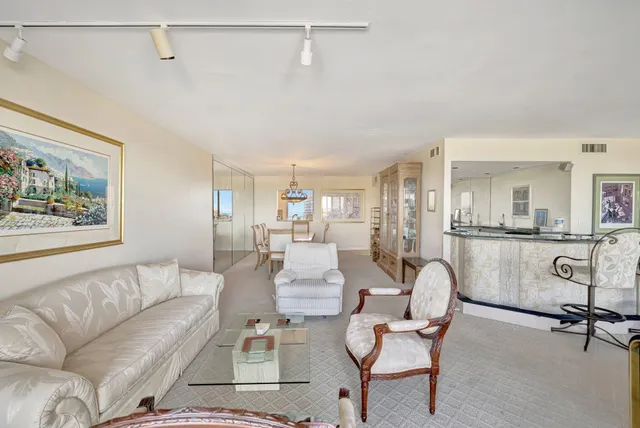 a room with table chairs and flat screen tv