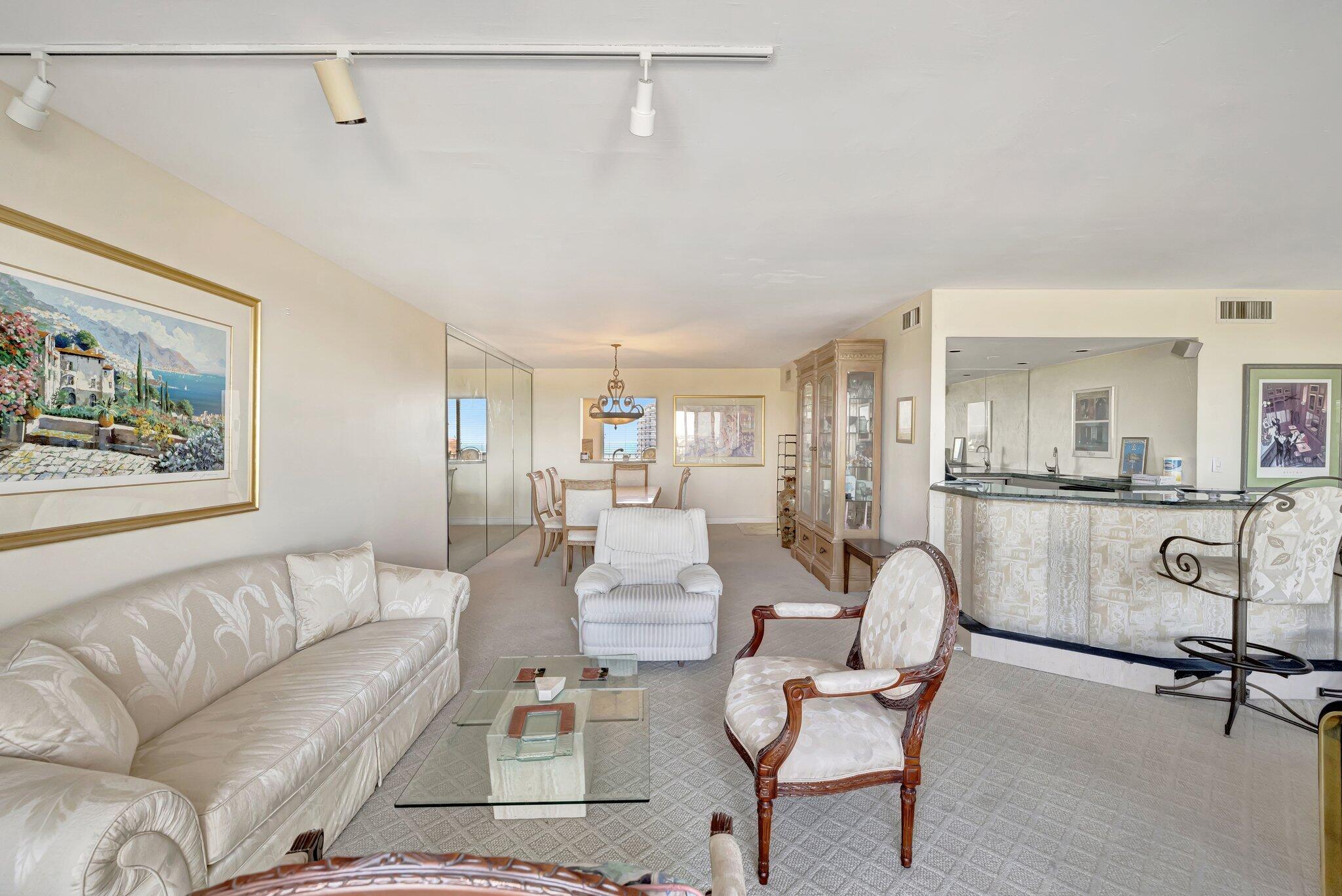 521 North Riverside Drive, Unit 1207 Pompano Beach, FL 33062 - Photo 20 of 50 a living room with furniture and a painting on the wall