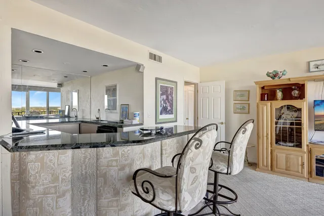 a large white kitchen with a large window