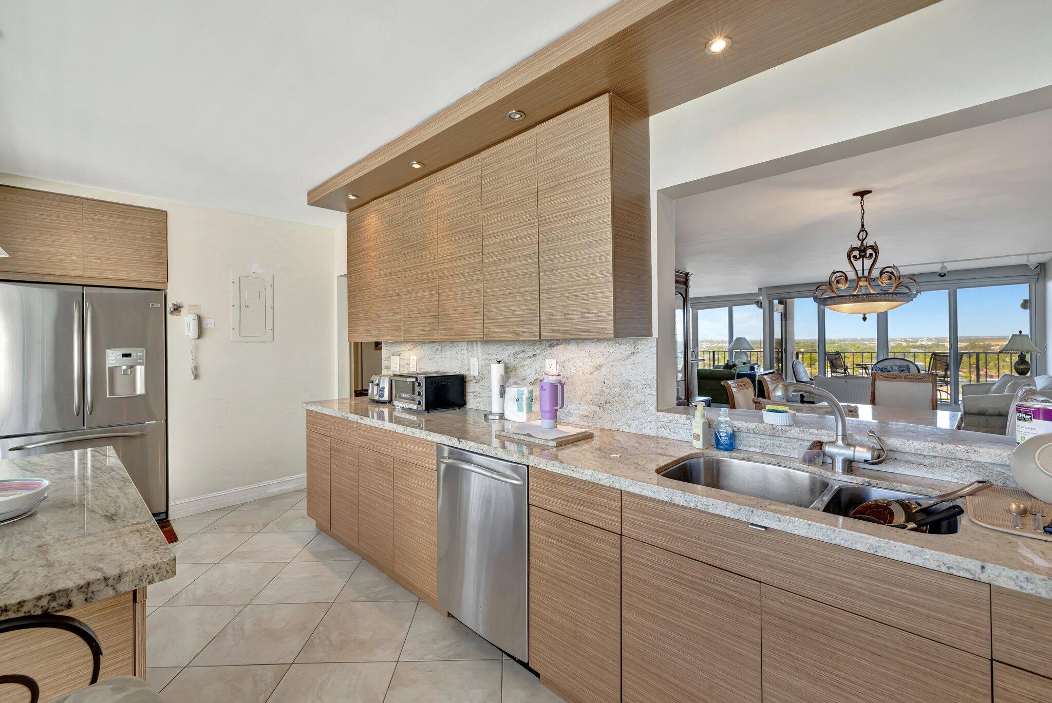 521 North Riverside Drive, Unit 1207 Pompano Beach, FL 33062 - Photo 27 of 50 a kitchen with sink refrigerator and stove