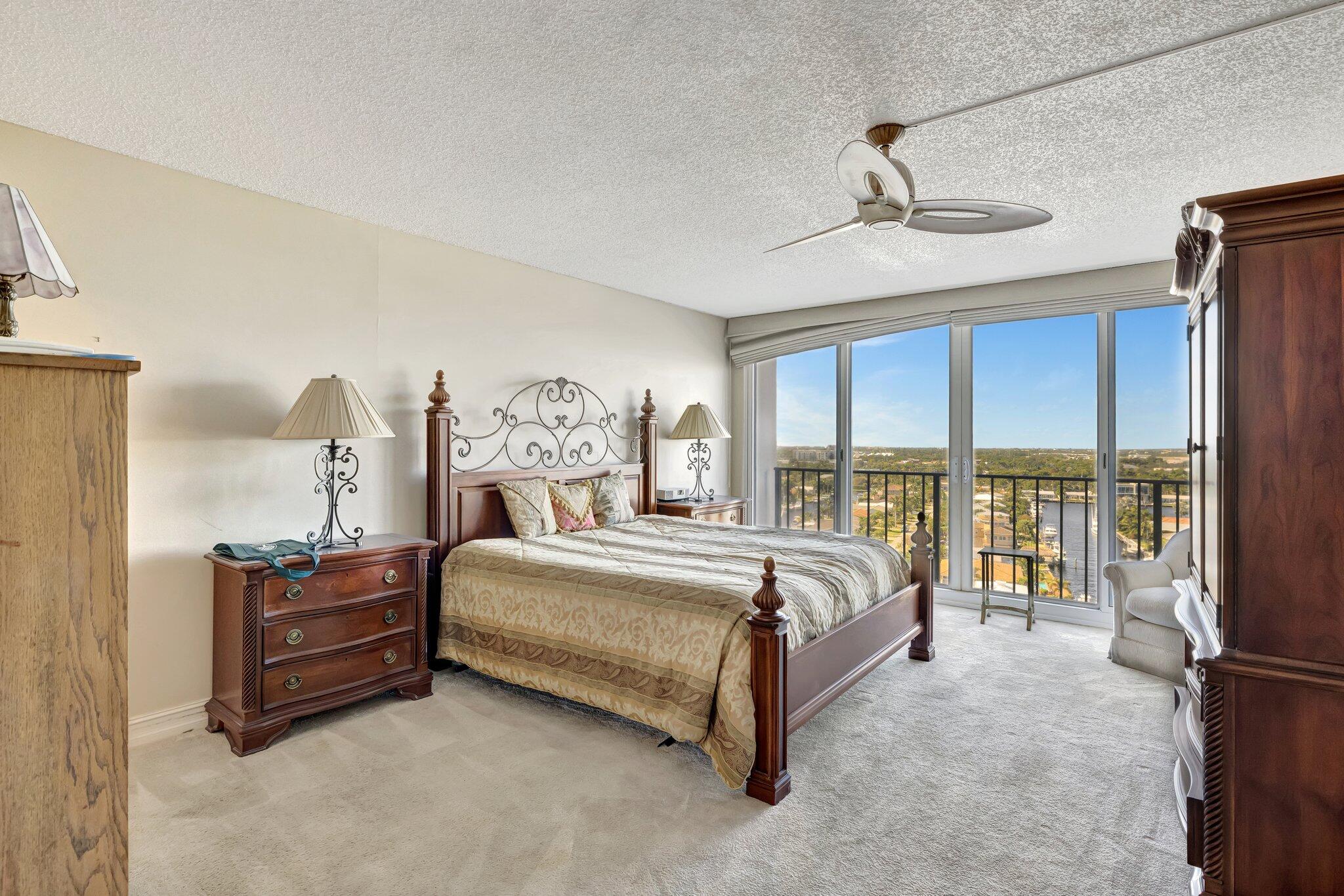 521 North Riverside Drive, Unit 1207 Pompano Beach, FL 33062 - Photo 30 of 50 a bed room with a bed and a chandelier