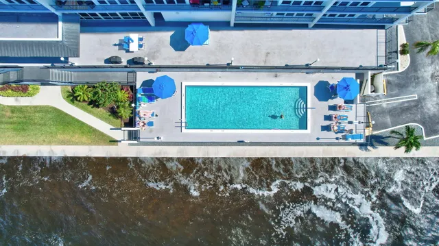 a living room with furniture and large windows