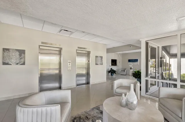 a spacious bedroom with furniture and a large window