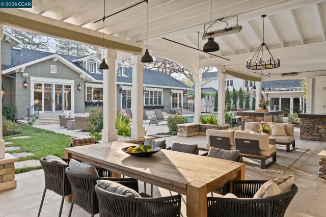 a kitchen with stainless steel appliances granite countertop a stove a sink dishwasher and white cabinets with wooden floor