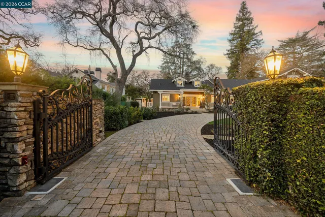 a front view of a house with yard and green space