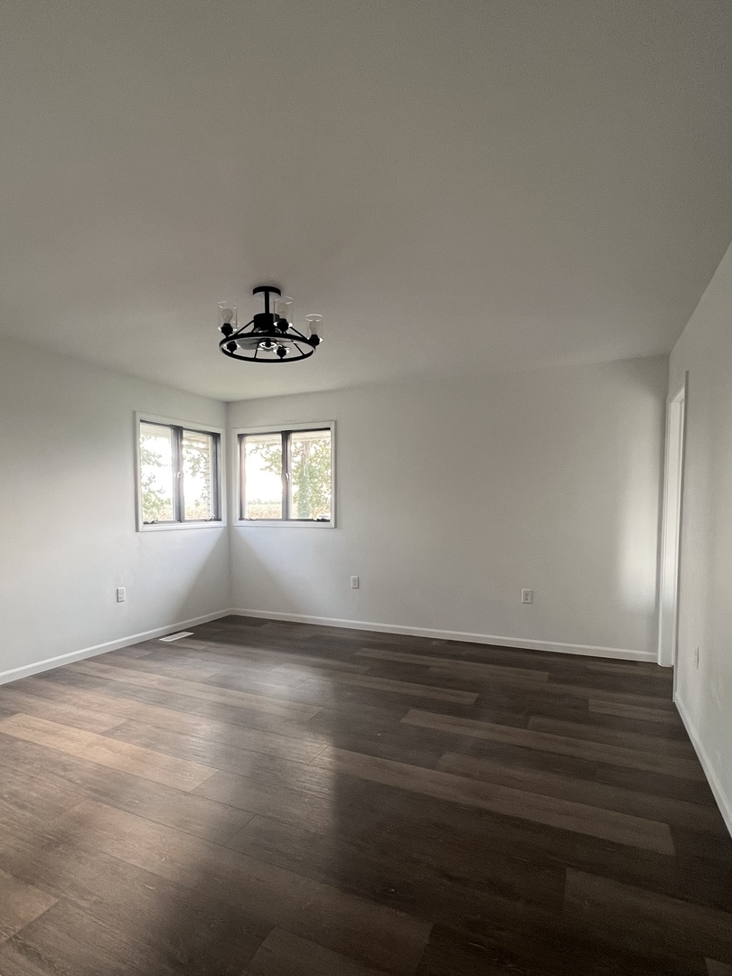 1285 South Gorman Road Mazon, IL 60444 - Photo 18 of 21 wooden floor in an empty room with a window