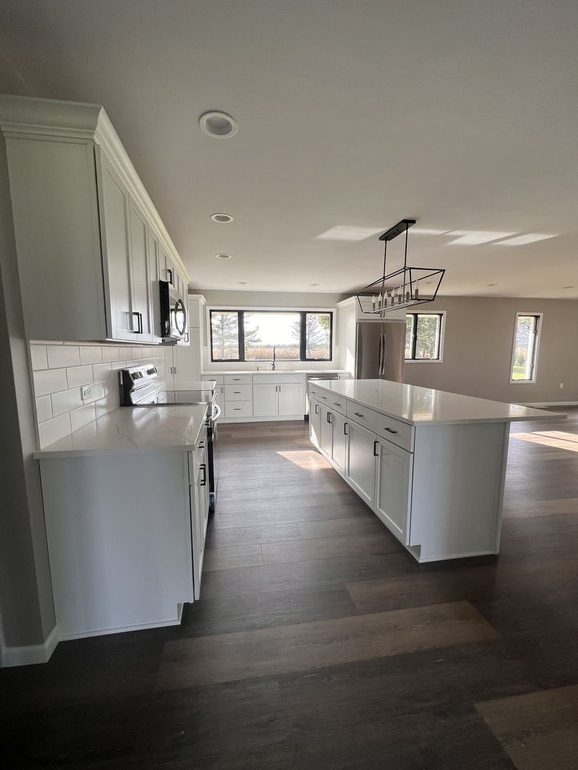 1285 South Gorman Road Mazon, IL 60444 - Photo 8 of 21 a kitchen with stainless steel appliances a stove top oven a sink and a refrigerator
