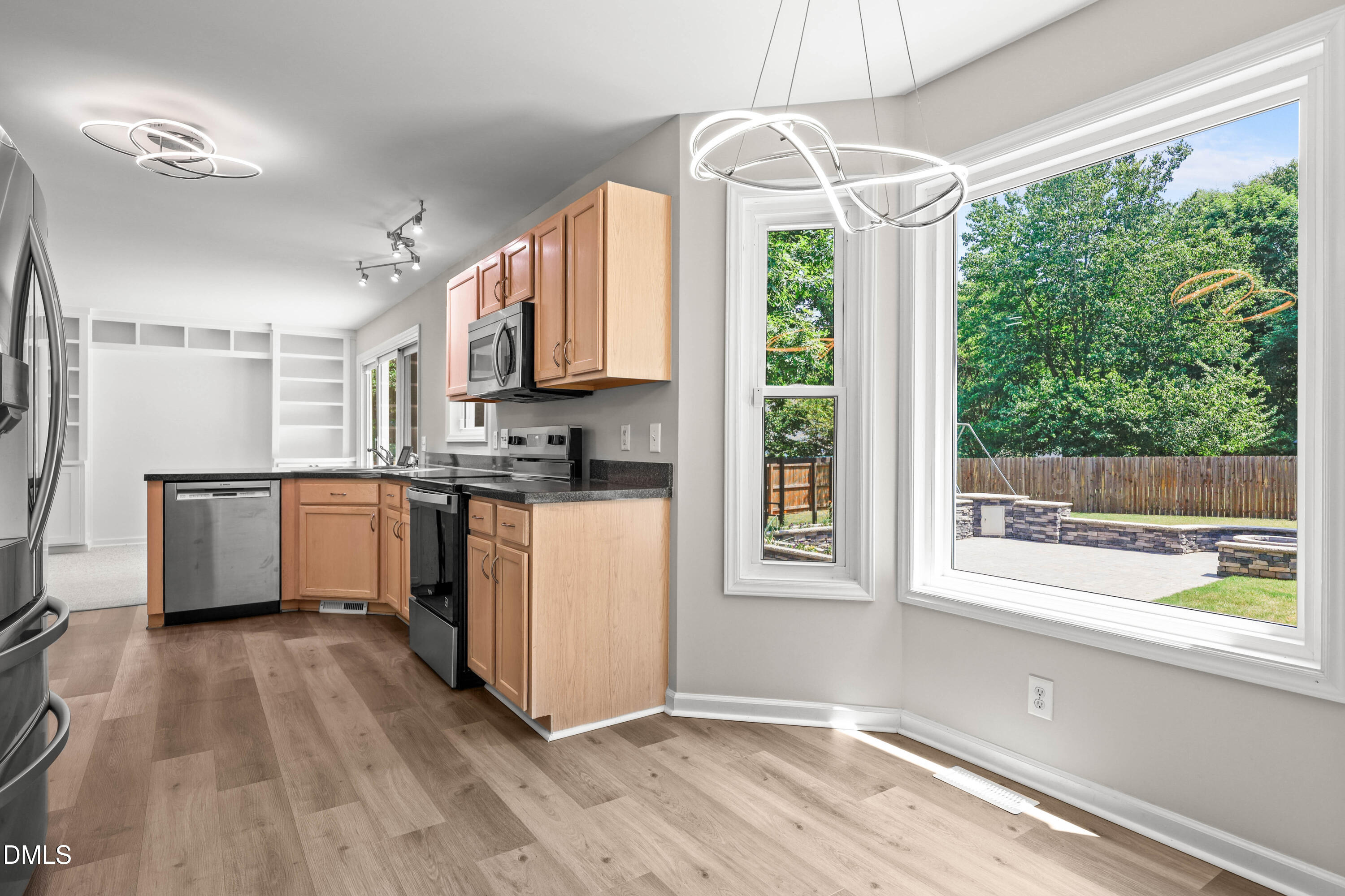 3015 Rennit Court Raleigh, NC 27603 - Photo 16 of 40 a kitchen with a window a sink and a refrigerator