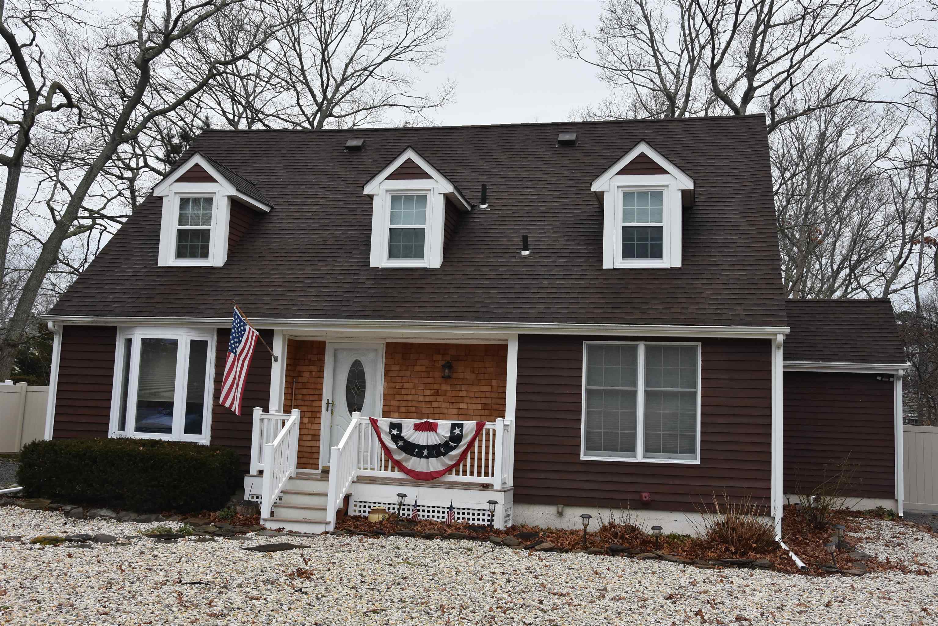 7 Corson Lane Ocean View, NJ 08230 - Photo 1 of 36 a front view of a house with a yard and garage