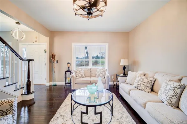 a living room with furniture a fireplace and a large window
