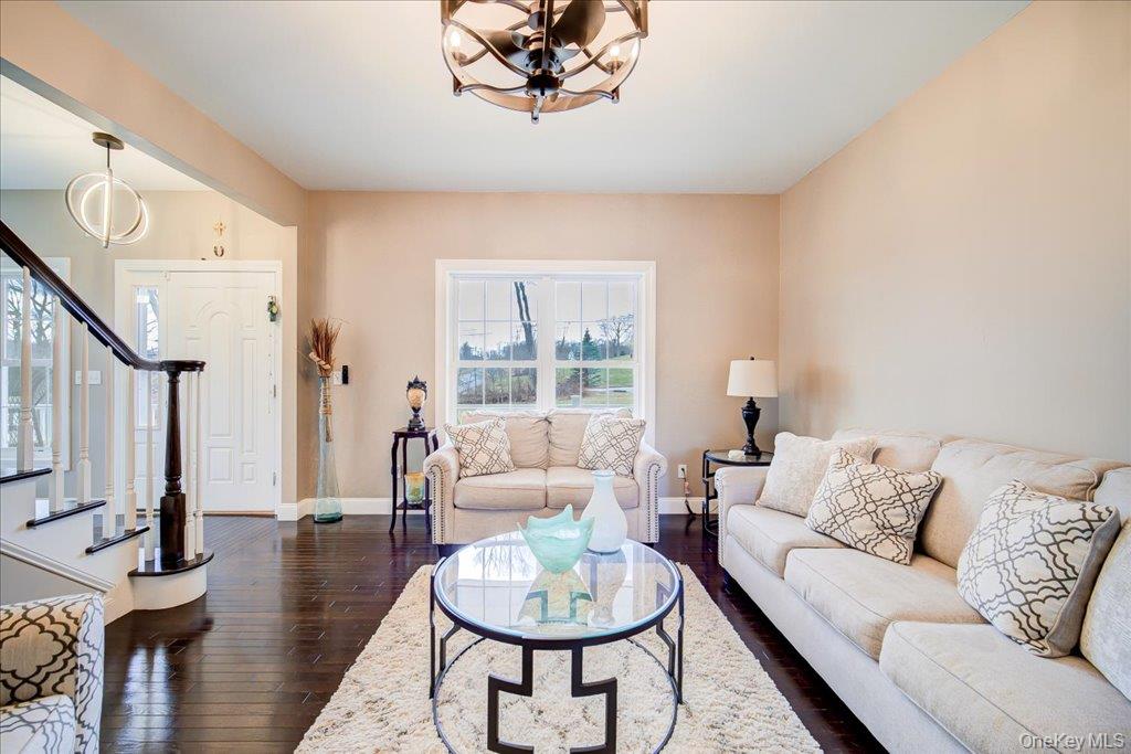 77 Houston Road Goshen, NY 10924 - Photo 11 of 46 a living room with furniture a fireplace and a large window