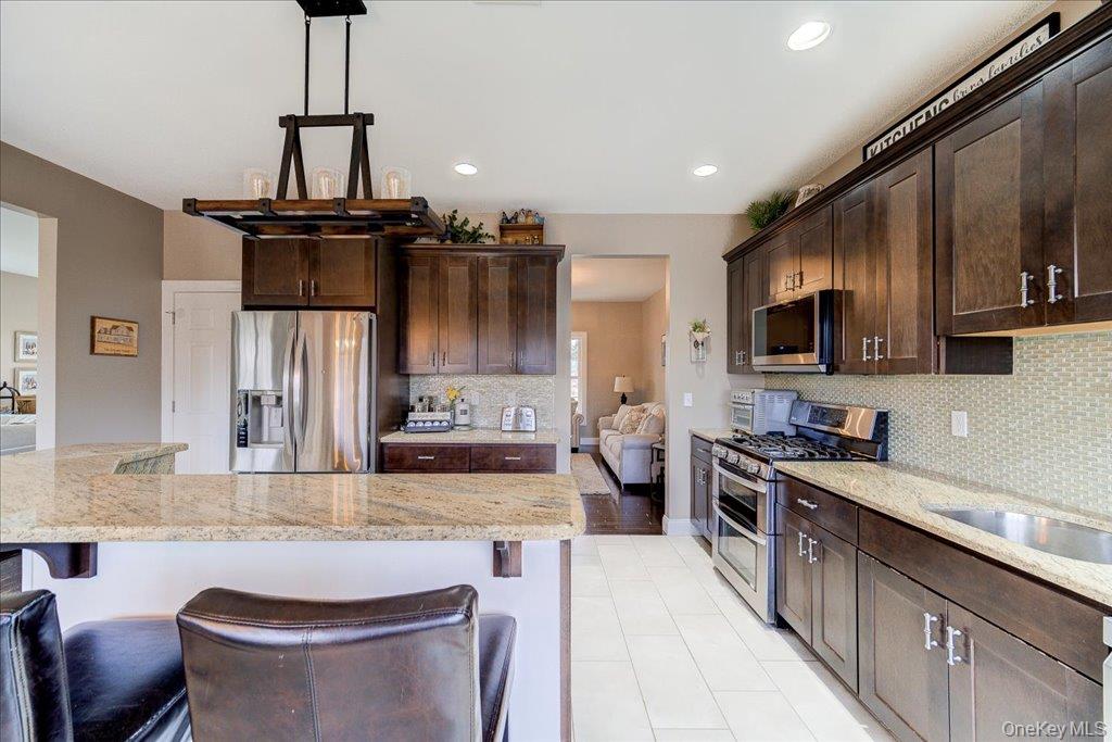 77 Houston Road Goshen, NY 10924 - Photo 14 of 46 a kitchen with stainless steel appliances kitchen island granite countertop a sink stove and refrigerator