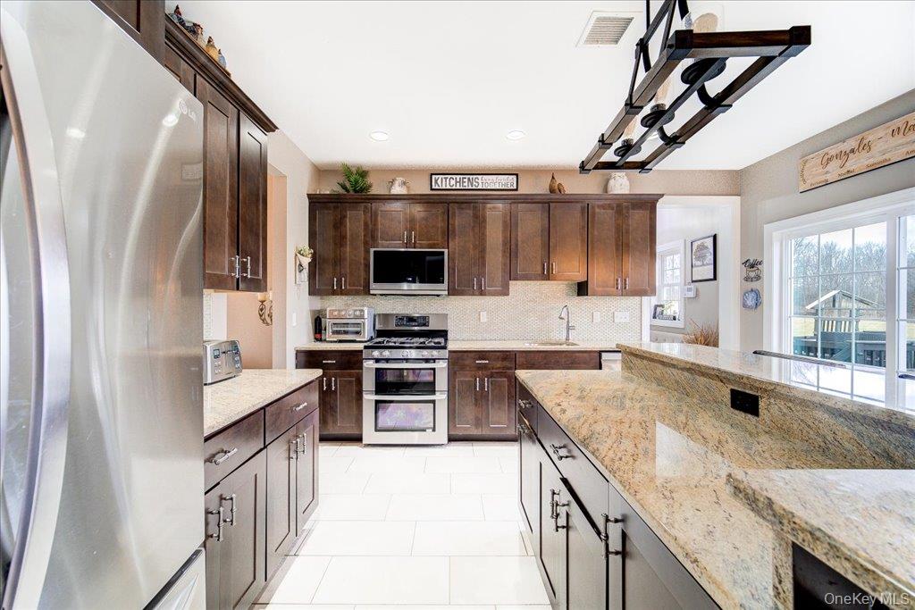 77 Houston Road Goshen, NY 10924 - Photo 15 of 46 a kitchen with stainless steel appliances granite countertop a sink stove and refrigerator