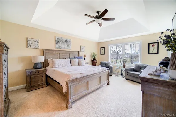 a bedroom with a bed a couch and a window