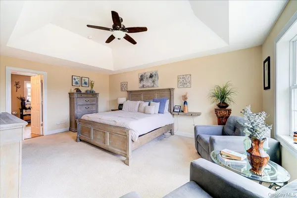 a bedroom with a bed a couch and a potted plant