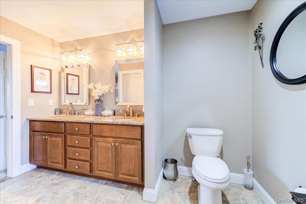77 Houston Road Goshen, NY 10924 - Photo 26 of 46 a bathroom with a granite countertop toilet sink and mirror