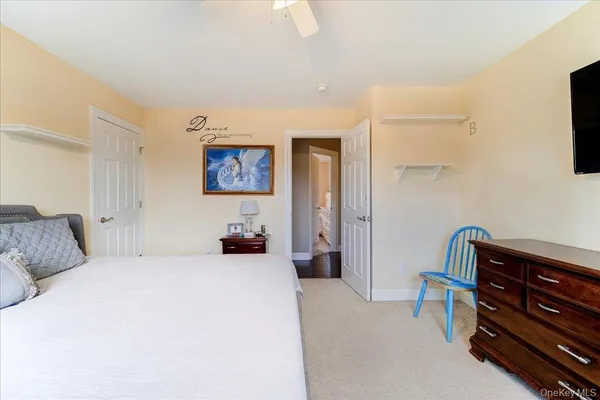 a bedroom with a bed and a dresser in it