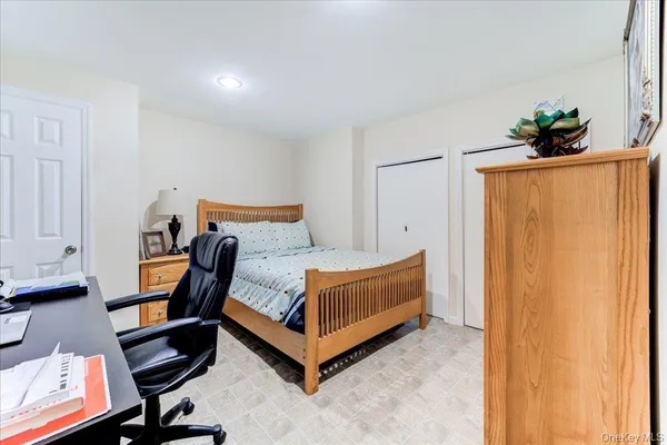a bedroom with a bed and a potted plant