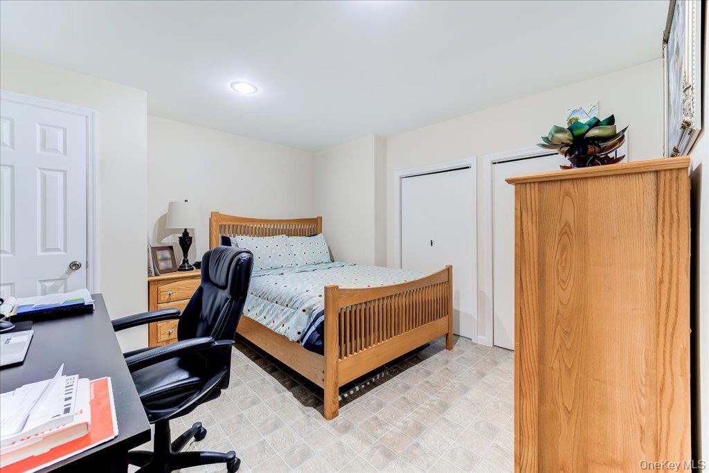 77 Houston Road Goshen, NY 10924 - Photo 37 of 46 a bedroom with a bed and a potted plant