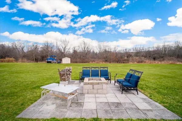 a view of yard with swimming pool and green space