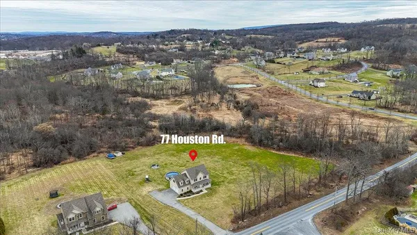 an aerial view of a house with yard