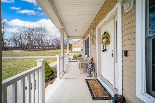 a view of a porch with furniture and garden