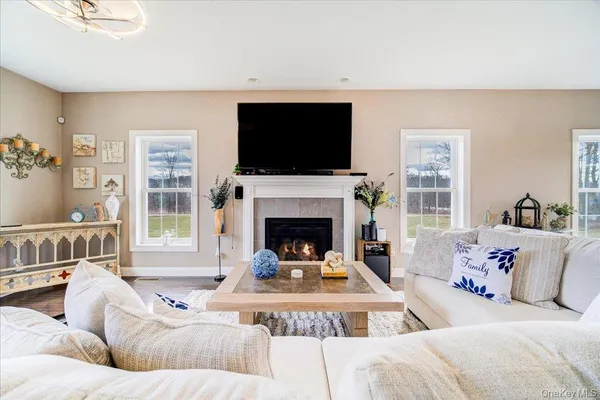 a living room with furniture fireplace and flat screen tv