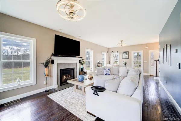 a living room with furniture a fireplace and a flat screen tv