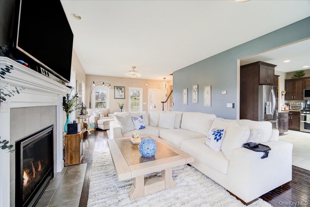 77 Houston Road Goshen, NY 10924 - Photo 9 of 46 a living room with furniture fireplace and a flat screen tv