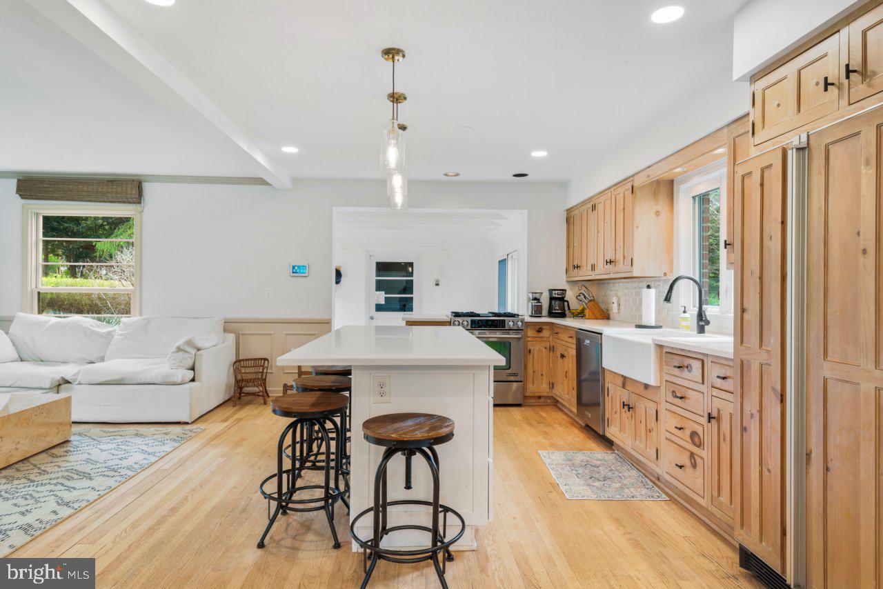 1803 Thornton Ridge Road Baltimore, MD 21204 - Photo 18 of 81 a kitchen with stainless steel appliances kitchen island granite countertop a stove a sink a refrigerator and white cabinets with wooden floor