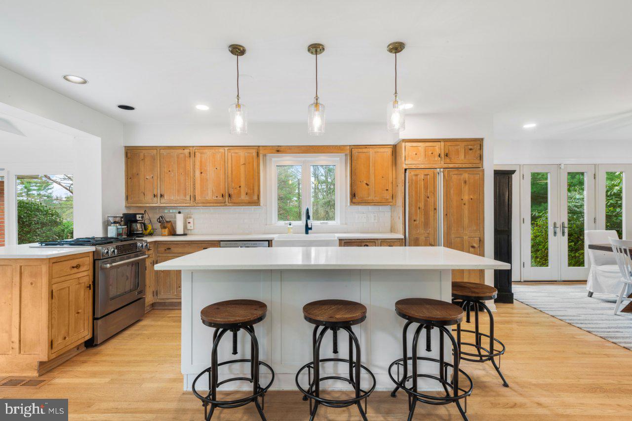 1803 Thornton Ridge Road Baltimore, MD 21204 - Photo 20 of 81 a kitchen with stainless steel appliances granite countertop a stove a sink a oven a dining table and chairs with wooden floor
