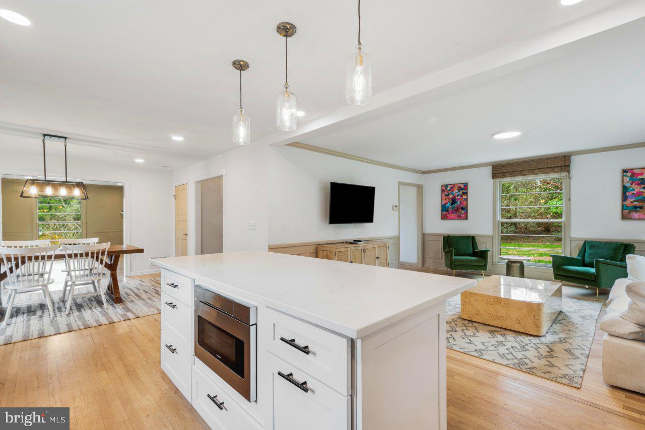 1803 Thornton Ridge Road Baltimore, MD 21204 - Photo 24 of 81 a view of kitchen with kitchen island a stove a sink a dining table and chairs with wooden floor